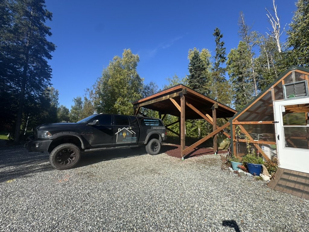 Finished carport build with the branded AKSHD truck parked in the yard