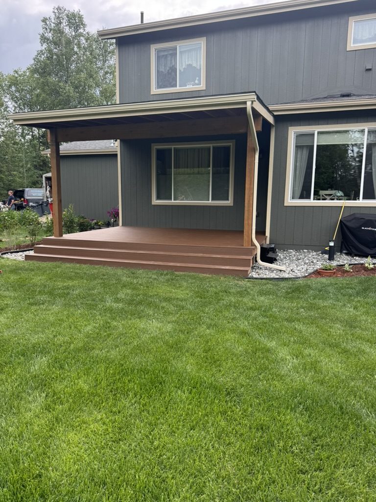 Covered deck and patio addition on a two-story home